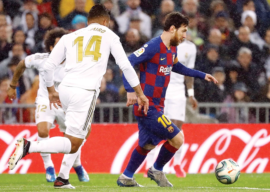 Barcelona’s Lionel Messi in action with Real Madrid’s Casemiro during their March 1 La Liga match at Santiago Bernabeu in Madrid. (File/Reuters)