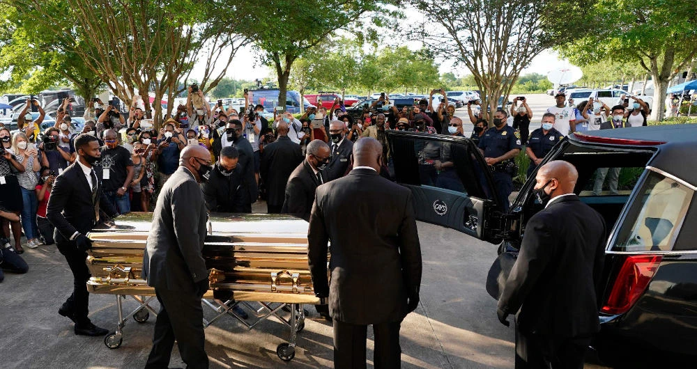 Pallbearers load the casket of George Floyd into a hearse after a public viewing at the Fountain of Praise church Monday, June 8, 2020, in Houston. (AFP)