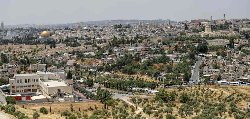 A picture taken on June 3, 2020, shows a view of the Palestinian neighbourhood of Wadi al-Joz (R) in east Jerusalem, and the Dome of the Rock Mosque (L) in Jerusalem's old city. (AFP)