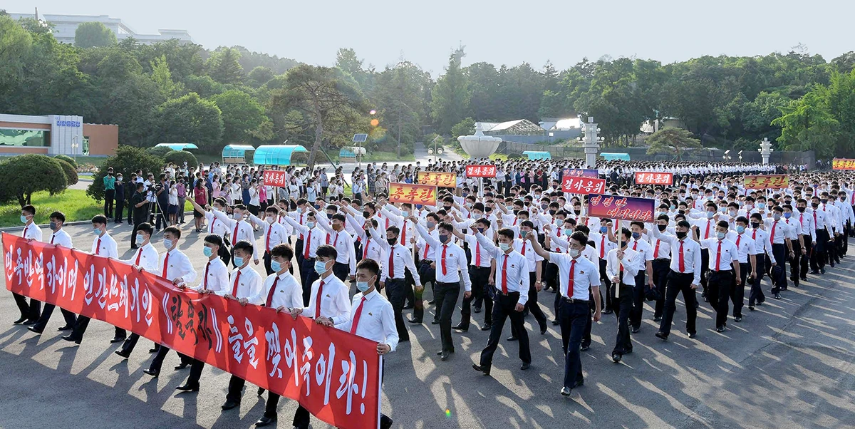 Youths and students wearing protective face masks participate in a demonstration against South Korea and North Korean defectors, in North Korea. (Reuters)