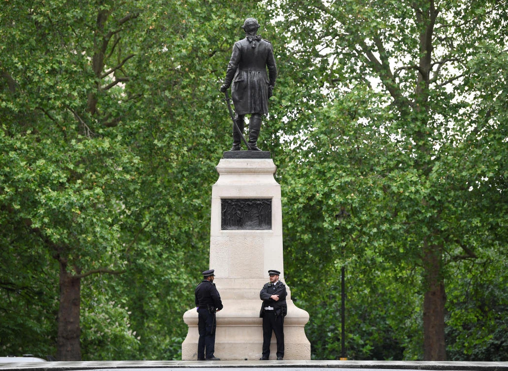 Police officers are seen on duty beside a statue of Clive of India in London, in the aftermath of protests against the death of George Floyd. (Reuters)