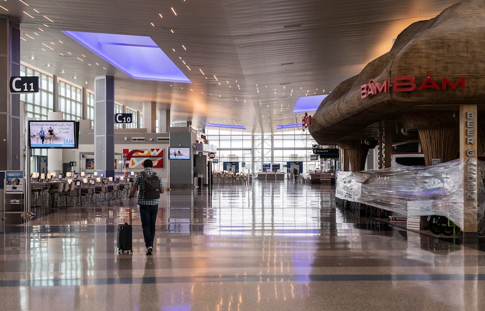 A man walks through an empty terminal at the George Bush Intercontinental in Houston, Texas on June 10, 2020, during the coronavirus pandemic. (AFP)