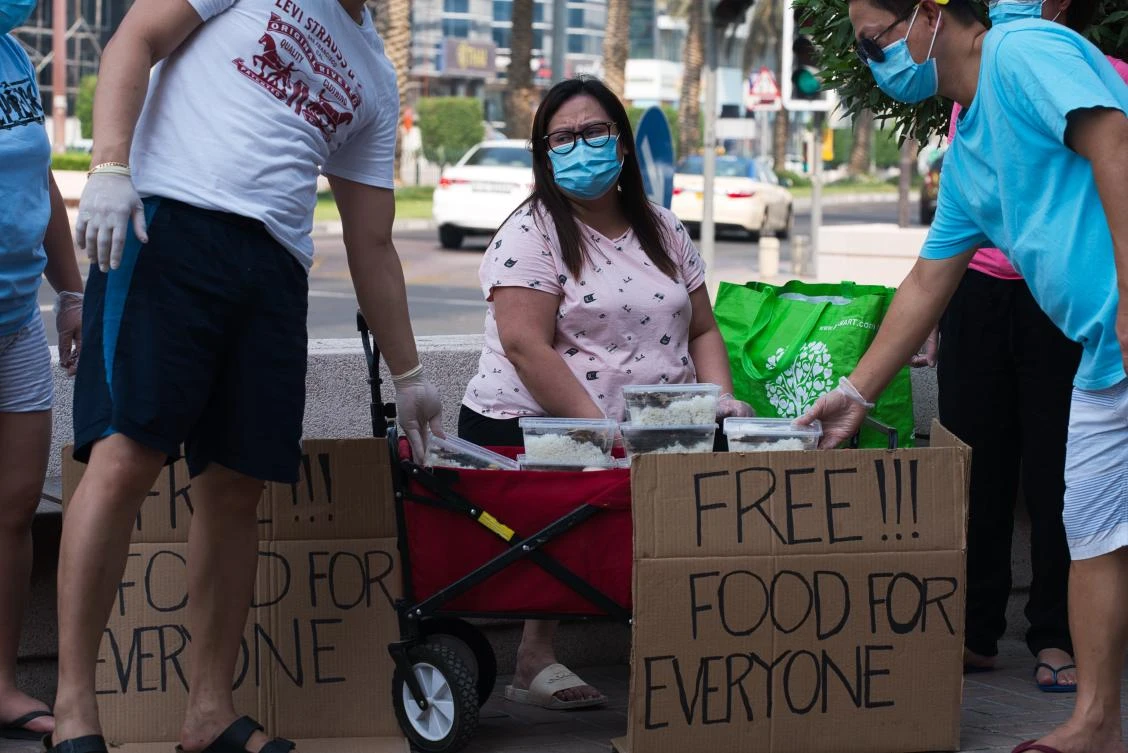 Feby Cachero Baguisa Dela Pena of Laguna, Philippines, hands out free food to those who need it in Dubai. (AP)
