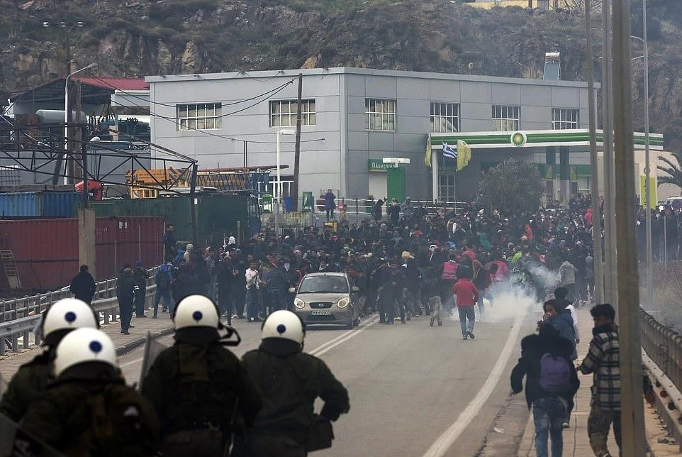 Riot police use tear gas against protesting refugees and migrants during a demonstration on the northeastern Aegean island of Lesbos, Greece. (AP Photo)