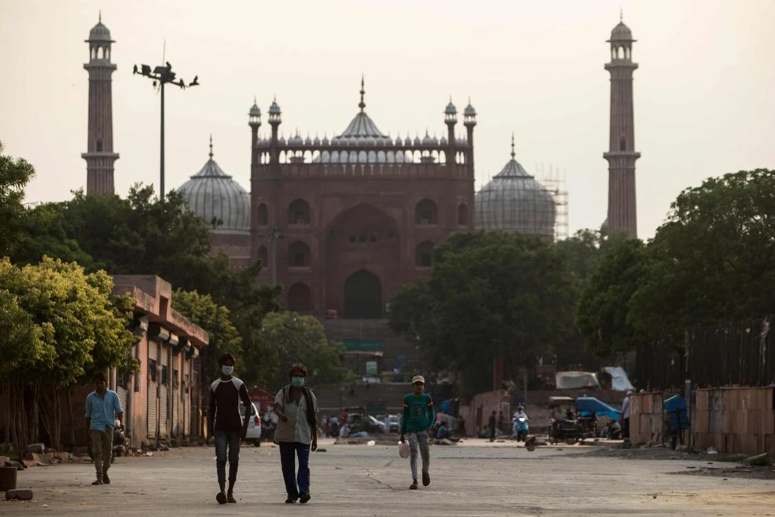 This file photo taken on June 5, 2020 shows people walking along a street outside the Jama Masjid after the government eased a nationwide lockdown imposed as a preventive measure against the COVID-19 coronavirus in the old quarters of New Delhi. (AFP)