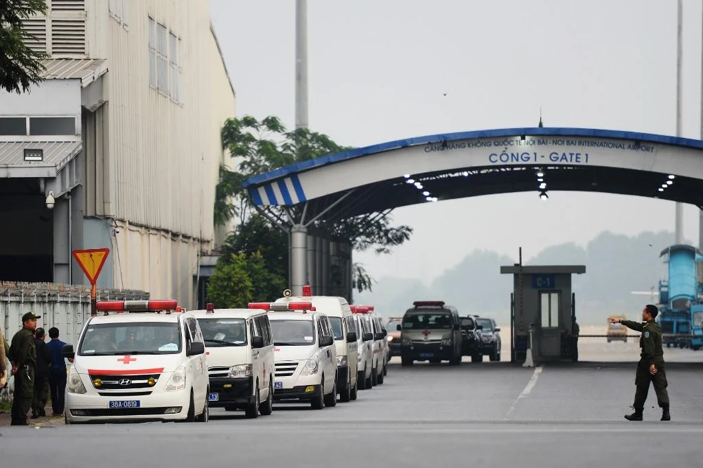 Vehicles carrying some of the remains of the 39 UK truck victims leave Noi Bai airport in Hanoi on November 27, 2019. (AFP)