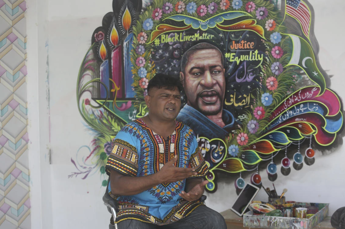 Pakistani truck-art artist Haider Ali speaks about the portrait of George Floyd he painted on the wall of his home in Karachi, Pakistan, Friday, June 12, 2020. (AP)