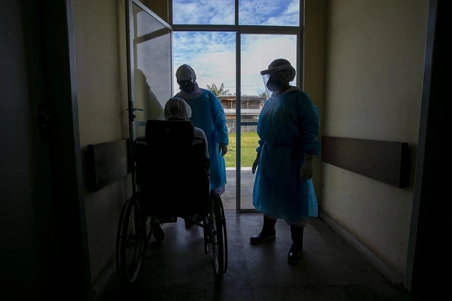 A COVID-19 patient prepares to be transfered by ambulance boat to a hospital in Breves city, Para state, after been hospitalized for five days in Melgaco, southwest of Marajo Island, in Brazil on June 10, 2020. (File/AFP)