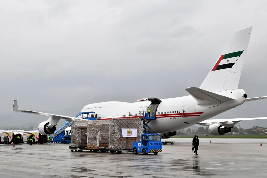 Bosnian airport workers unload cargo from a Boeing 747-400 airplane owned by the United Arab Emirates government after it landed at Sarajevo International Airport, on May 27, 2020, carrying a donation of 20 tons of medical equipment and protective gear, donated to Bosnia and Herzegovina by the UAE's prime minister to aid in fighting the spread of the COVID-19 pandemic, caused by the novel coronavirus. (File/AFP)