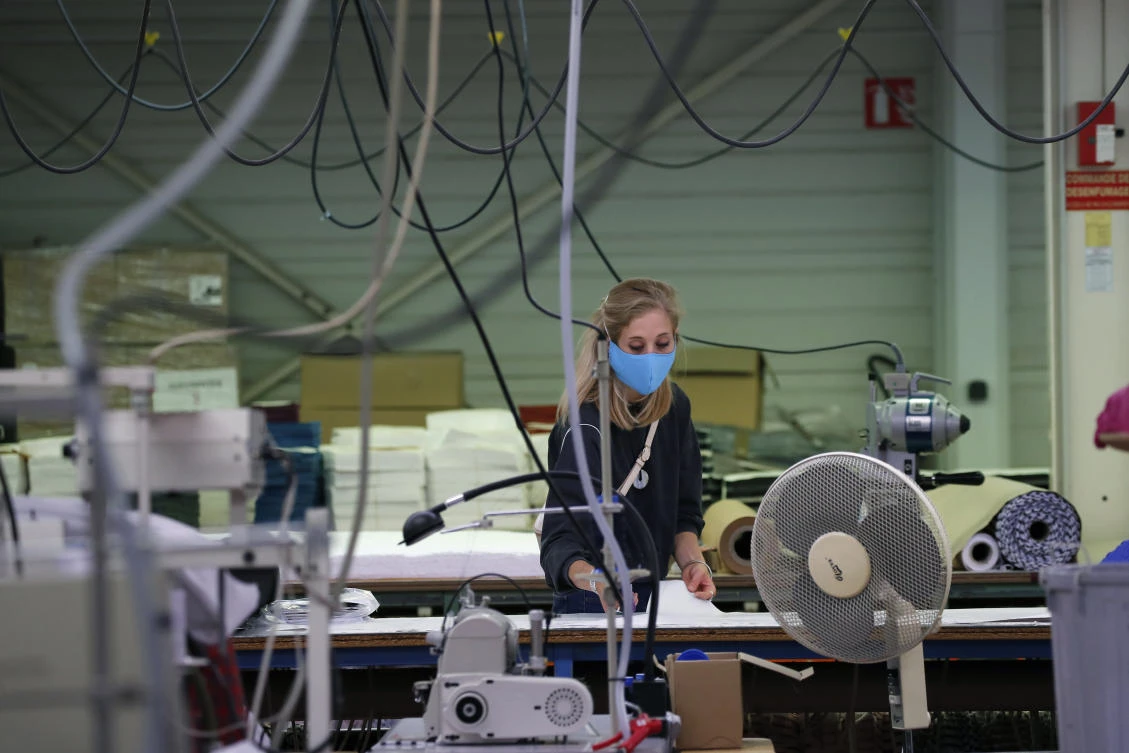 In this Friday, June 20, 2020 photo, an employee cuts fabrics in Chanteclair Hosiery, a French knitwear clothing manufacturer in Saint Pouange, east of Paris Friday June 12, 2020. (AP)