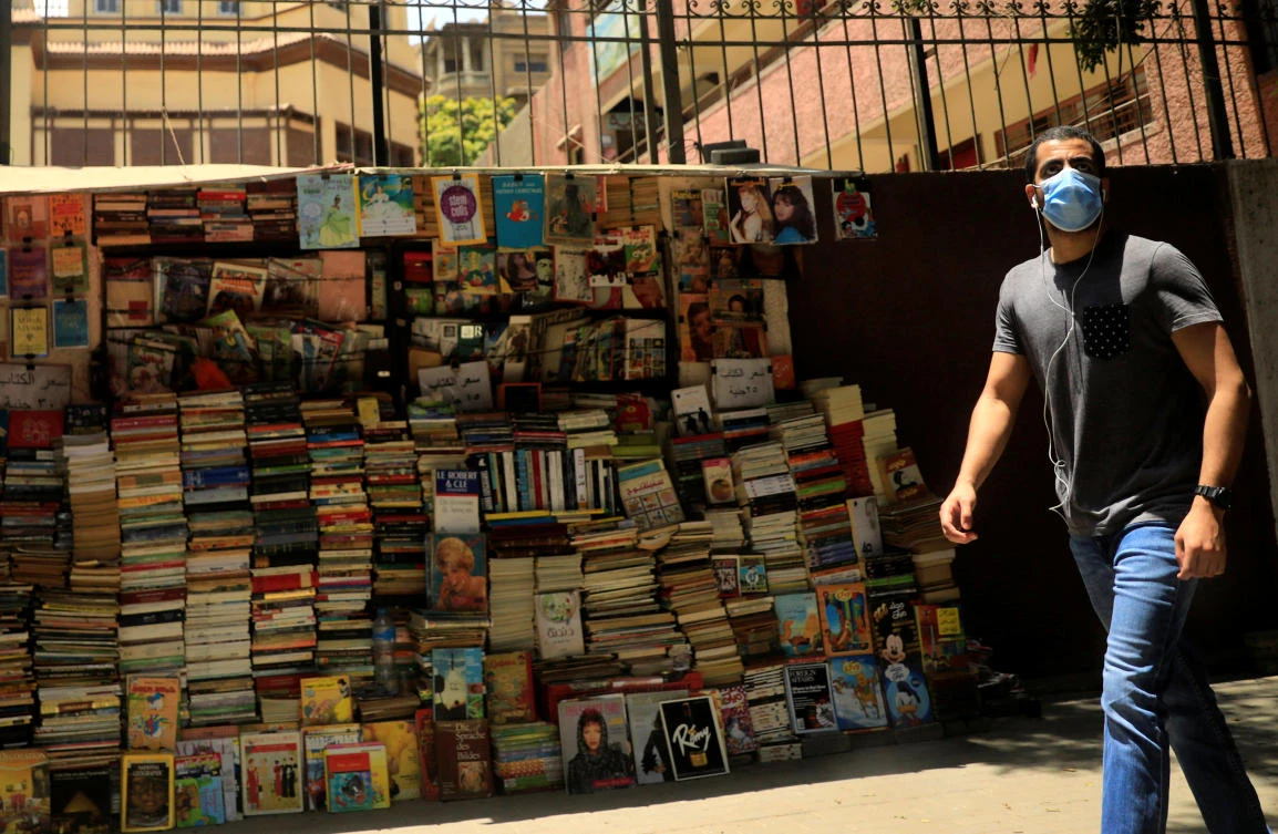 A man wearing a protective face mask walks past a bookstand on street in central Cairo, amid concerns over the coronavirus disease (COVID-19) in Egypt June 11, 2020. (Reuters)