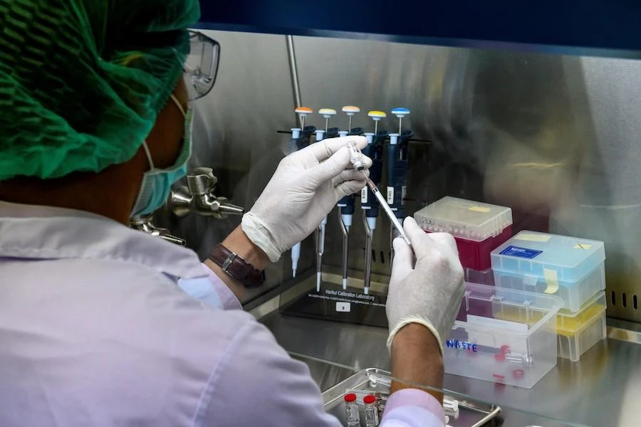 A laboratory technician fills a syringe with a COVID-19 novel coronavirus vaccine candidate ready for trial on monkeys at the National Primate Research Center of Thailand at Chulalongkorn University in Saraburi. (File/AFP)
