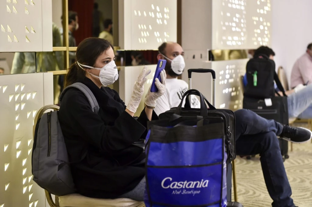 Lebanese nationals wait at a Beirut hotel where they will be housed for quarantine after their repatriation from Saudi Arabia on April 5, 2020. (AFP)