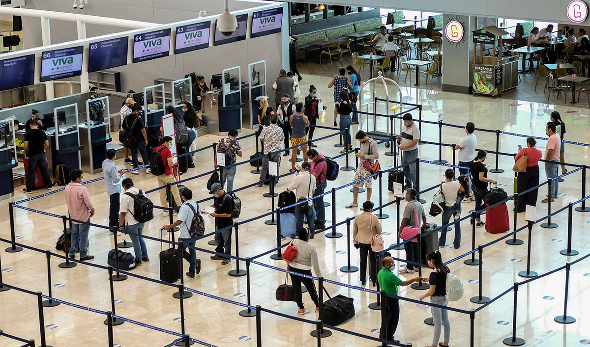 Tourists wait to check in at the airport in Cancun, Mexico on Saturday. (AP)
