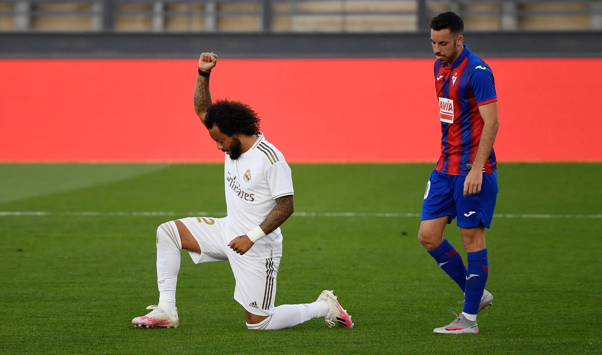 Real Madrid's Brazilian defender Marcelo kneels on the field to celebrate his goal during the Spanish League football match between Real Madrid CF and SD Eibar at the Alfredo di Stefano stadium in Valdebebas, on the outskirts of Madrid, on June 14, 2020. (AFP)