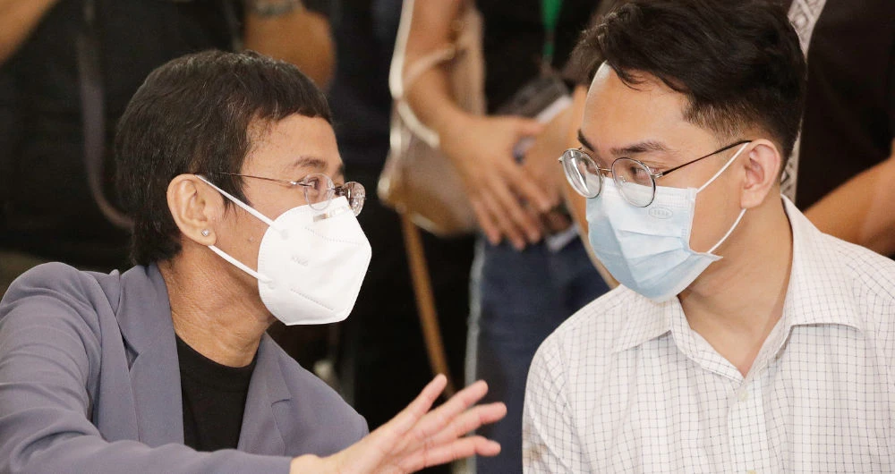 Rappler’s Maria Ressa, left, and Reynaldo Santos Jr. during a press conference in Manila on Monday, after the court convicted the duo of cyber libel. (AP)