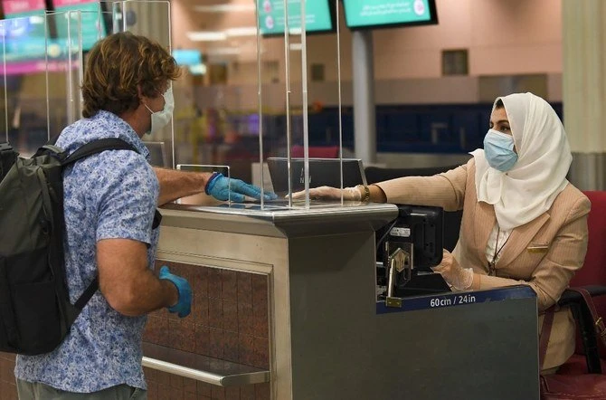 A passenger checks in for an Emirates flight at Dubai airport. (AFP/File)