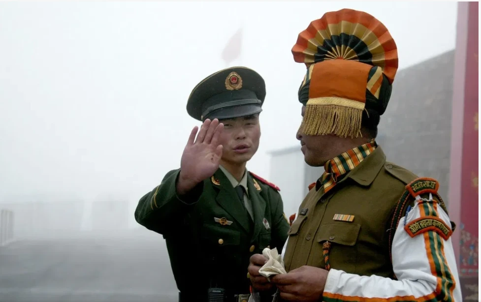 A Chinese soldier and an Indian soldier on the Chinese side of the ancient Nathu La border crossing between India and China. (AFP)