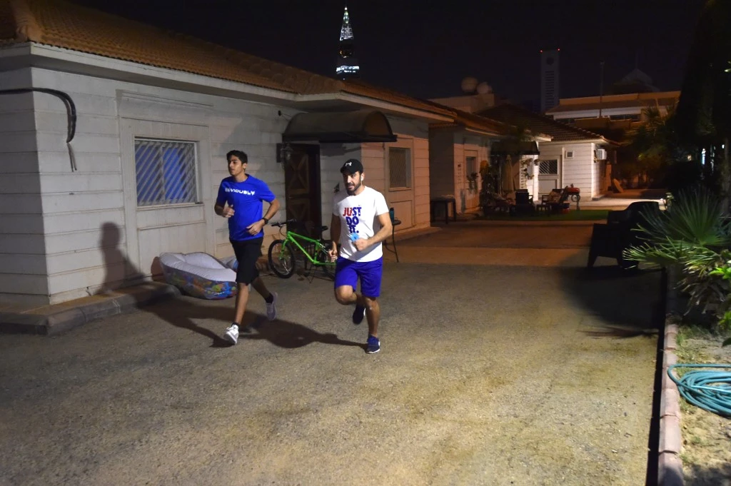 Expats living at compound in the Saudi capital Riyadh, run during a marathon race, an initiative launched by the Saudi sports ministry to encourage people to stay fit during the lockdown. (AFP)
