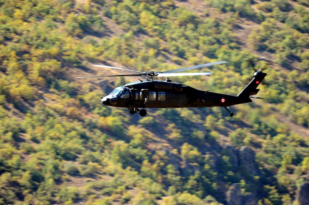 In this file photo taken on October 21, 2011 a Turkish army helicopter hovers above the base of the Cukurca brigade in the Cukurca region of the Turkish province of Hakkari. (AFP)