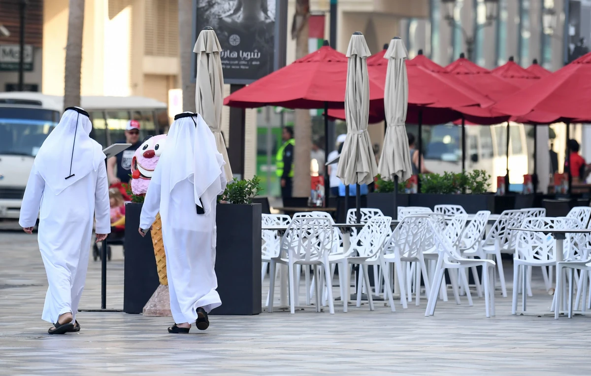 Emiratis walk along the empty beachside boulevard of Jumeirah Beach Residence in Dubai on March 12, 2020. (AFP/File Photo)