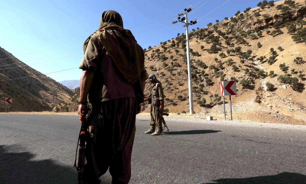 In this file photo taken on June 22, 2018, members of the Kurdistan Workers' Party (PKK) carry rifles as they stand guard on a road in the Qandil Mountains, the PKK headquarters in northern Iraq. (AFP)