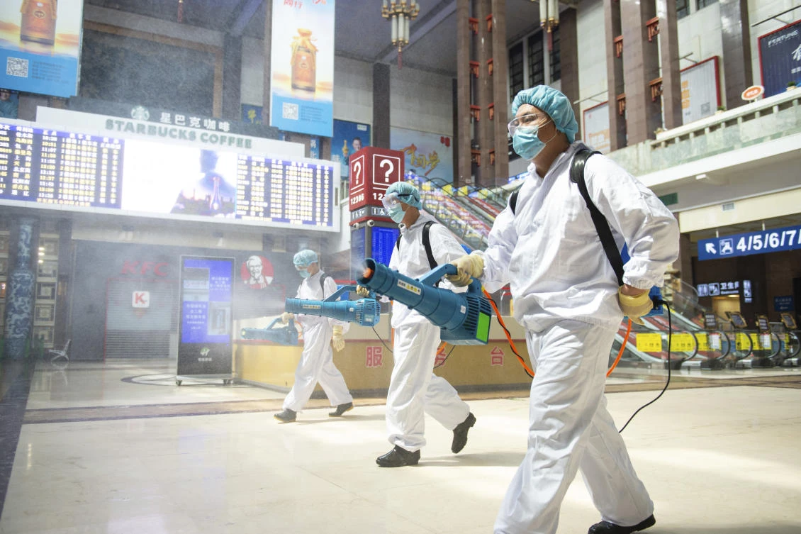In this June 18, 2020, photo released by China's Xinhua News Agency, workers spray disinfectant in the central hall of the Beijing Railway Station in Beijing. New confirmed cases of coronavirus remained stable in China's capital on Friday after a public health official declared Beijing's latest outbreak under control. (AP)