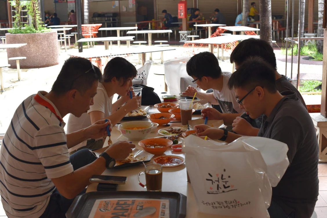 A group of five people have lunch together at the Newton Food Center Friday, June 19, 2020, in Singapore. Singaporeans can now wine and dine at restaurants, work out at gyms and get together with five people or less after most lockdown restrictions were lifted Friday. (AP)