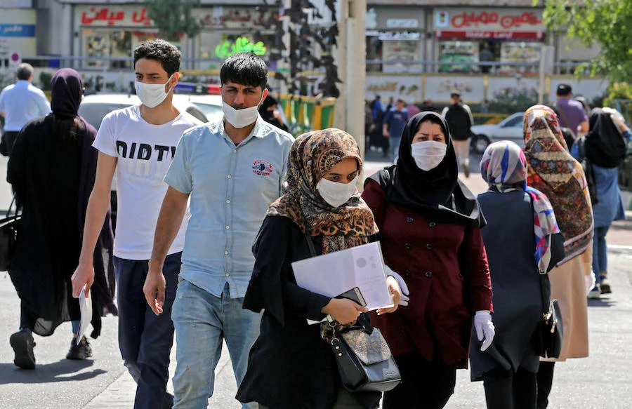 Iranians, mostly wearing face masks, are pictured in the capital Tehran on June 16, 2020 amid the coronavirus Covid-19 pandemic crisis. (AFP)