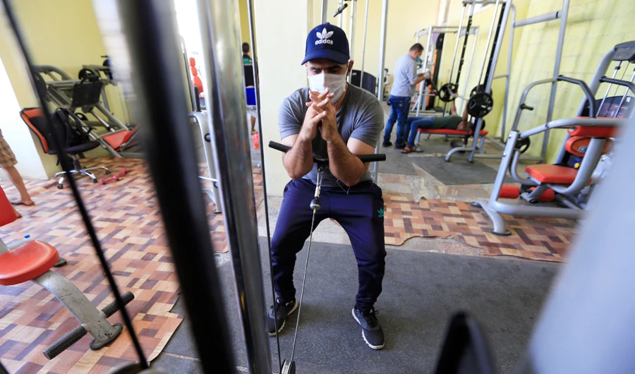 Yemeni men wearing face masks as a protection against the Covid-19 coronavirus train at a gym in the Yemeni capital Sanaa on June 17, 2020 as private gyms open respecting social distancing to prevent the spread of the disease. (AFP)