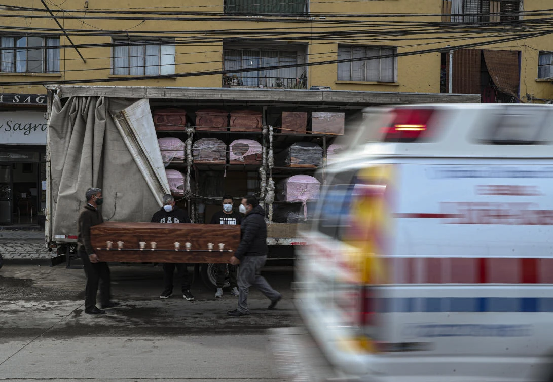 Bergut Funeral Services, above, has seen its orders boom and its workshop is making 100 coffins a week, double the pre-pandemic number. (AP)