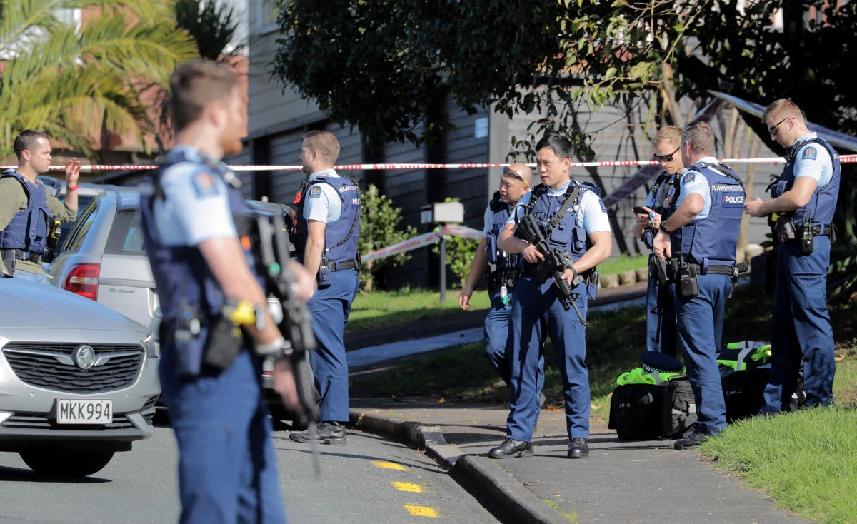 Armed police gather at the scene of a shooting incident following a routine traffic stop in Auckland, New Zealand, Friday, June 19, 2020. New Zealand police say a few officers have been shot and seriously injured and a suspect is on the run. (AP)