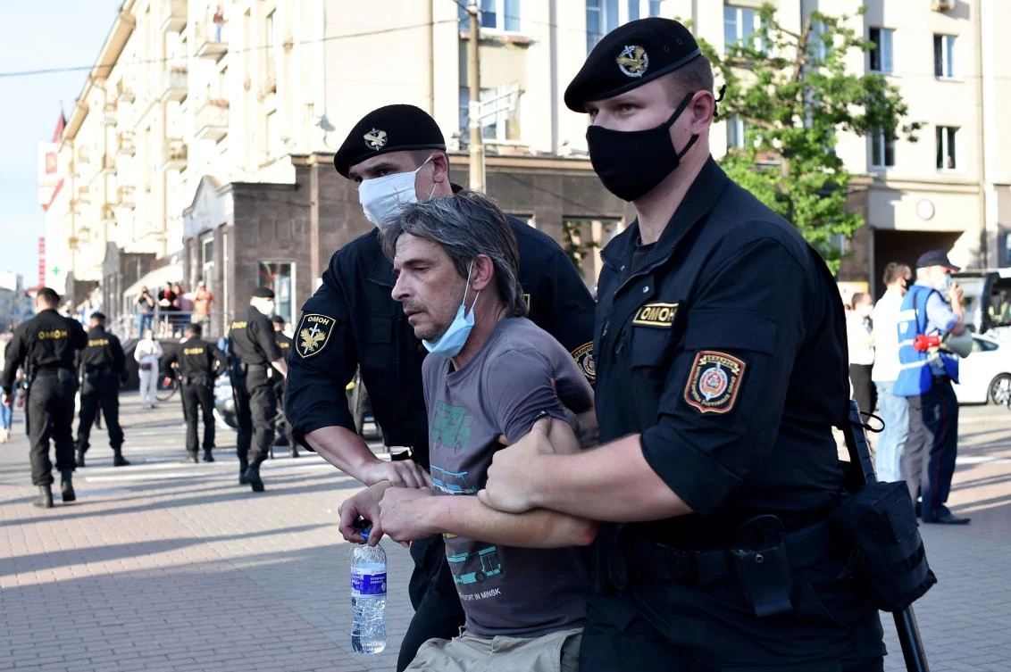 Belarus' riot police officers detain an opposition supporter during a gathering to support candidates seeking to challenge President Alexander Lukashenko in August's polls in Minsk on June 19, 2020. (AFP)