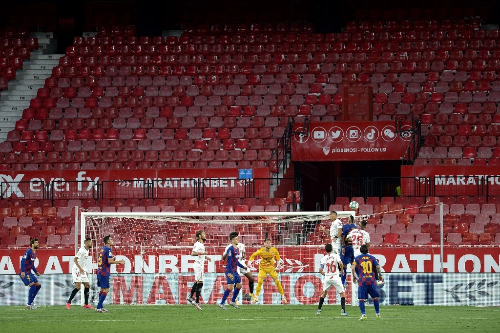 Barcelona and Sevilla football players play to an empty Ramon Sanchez Pizjuan stadium during a Spanish league match in Seville on June 19, 2020. (AFP)