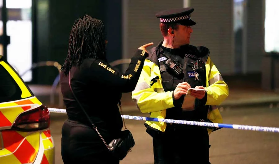 A person speaks to a police officer at a cordon after reported multiple stabbings in Reading, Britain, June 20, 2020. (REUTERS)