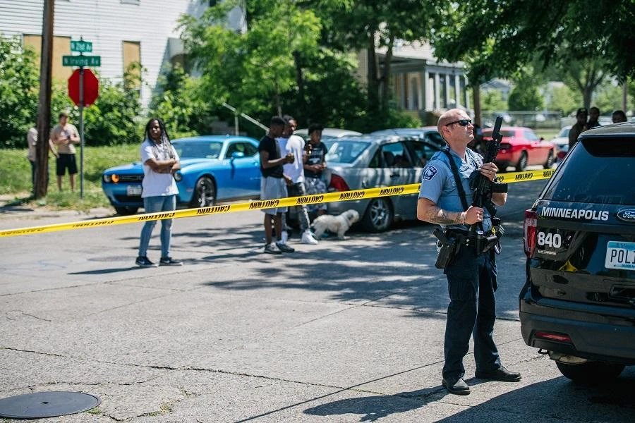 A Minneapolis Police officer stands behind caution tape at a crime scene on June 16, 2020 in Minneapolis, Minnesota. (File/AFP)
