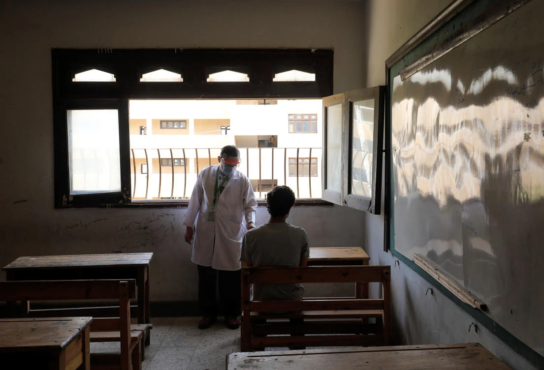 A doctor monitors an Egyptian high school coronavirus disease (COVID-19) positive student in an isolated room during the first day of final exams, in Cairo, Egypt June 21, 2020. (Reuters)