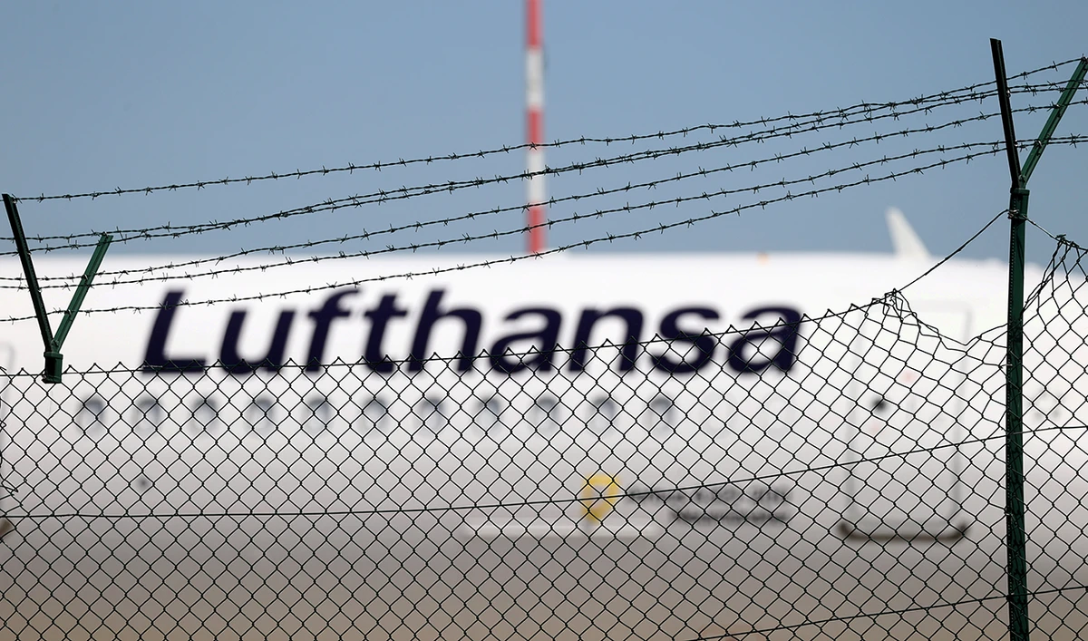 A Lufthansa jet is seen behind a barbed-wire fence at the airport as the spread of coronavirus disease (COVID-19) continues in Frankfurt, Germany, June 2, 2020. (Reuters)