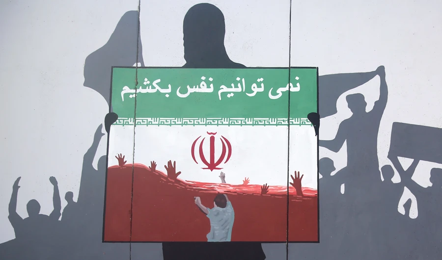 A view of a painting on a wall reading ‘We cannot breathe’ in Dari language during a protest in Kabul on Monday against killings of Afghans refugees in Iran. (AP)