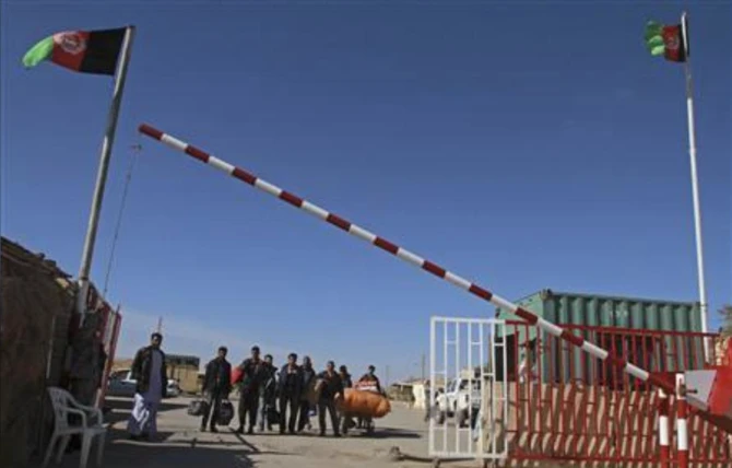 A group of Afghan migrant workers enter Afghan territory after leaving Iran at the Islam Qala border in Herat province November 5, 2012. (Reuters)