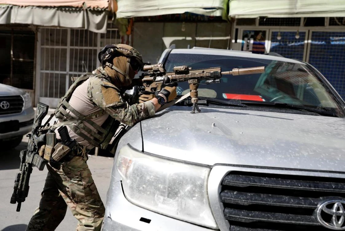 A foreign soldier takes position during an attack in Kabul, Afghanistan. (Reuters)