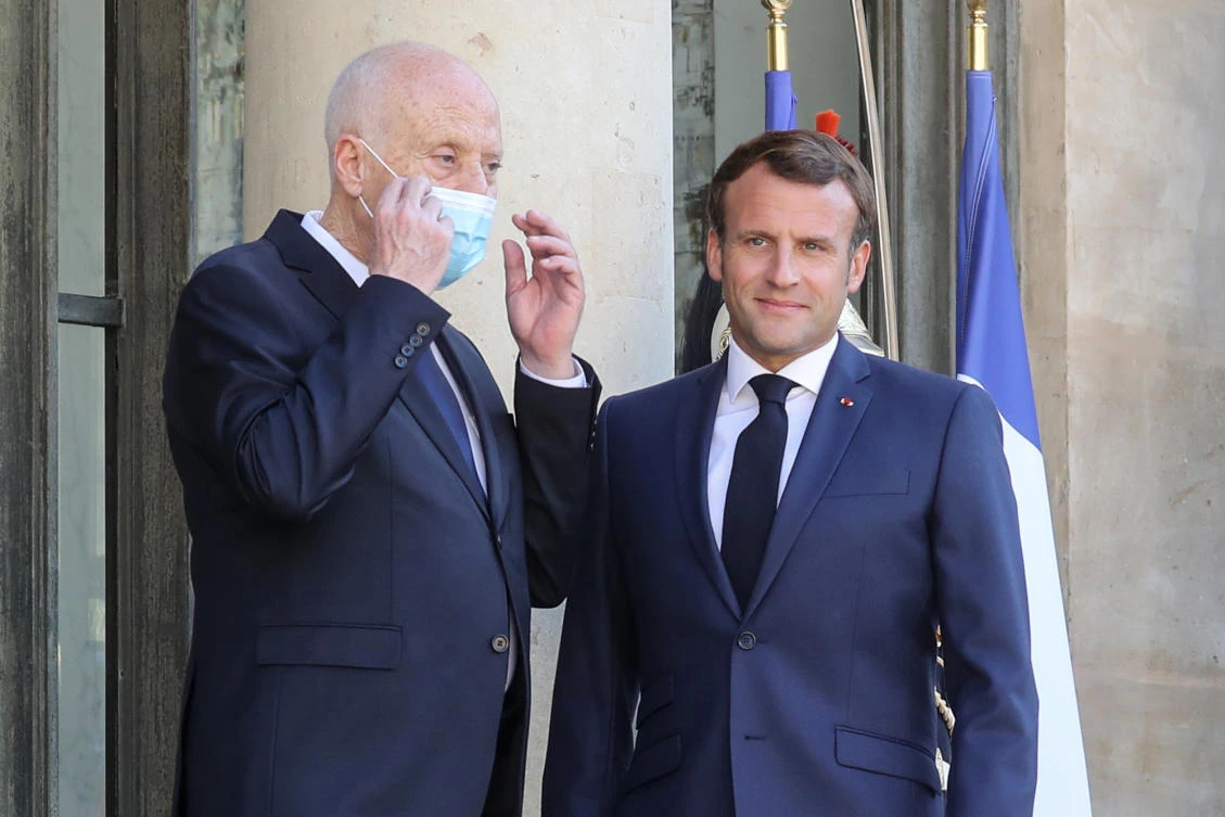 Tunisian President Kais Saied (L), removes his face mask as he is welcomed by French President Emmanuel Macron at the Elysee Palace, in Paris, on June 22, 2020. (AFP)