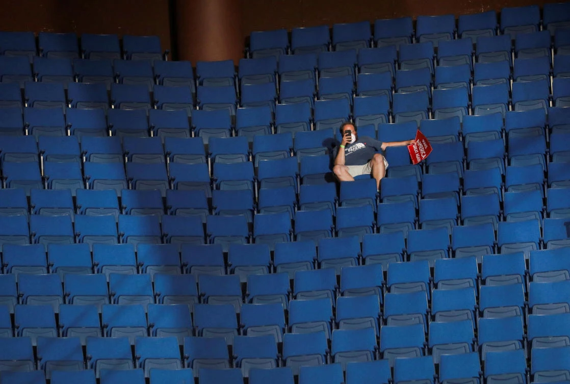 A supporter of US President Donald Trump shoots a video with his mobile phone from the sparsely filled upper decks of the BOK Center in Tulsa, Oklahoma, US, June 20, 2020. (Reuters)