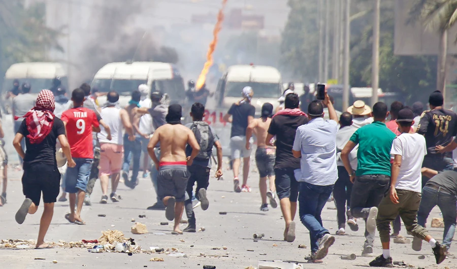 Tunisian protesters clash with security forces as they demonstrate in the southern city of Tataouine on Monday demanding authorities make good on a 2017 promise to provide jobs to thousands of unemployed. (AFP)