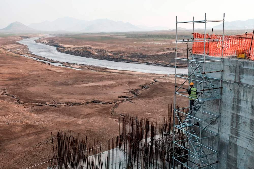 A worker goes down a construction ladder at the Grand Ethiopian Renaissance Dam (GERD), near Guba in Ethiopia, on December 26, 2019. (AFP)