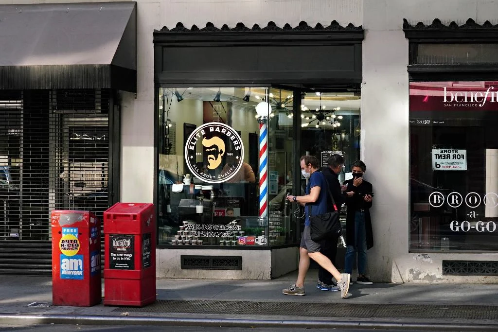 People wait outside a barber shop as New York moves into phase 2 of re-opening following restrictions imposed to curb the coronavirus pandemic on June 23, 2020. (Getty Images/AFP)