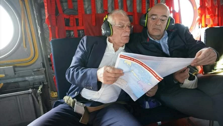 Nikos Dendias, right, and Josep Borrell study a map as they fly to Evros on Greece’s northeastern border with Turkey. (Twitter Photo)