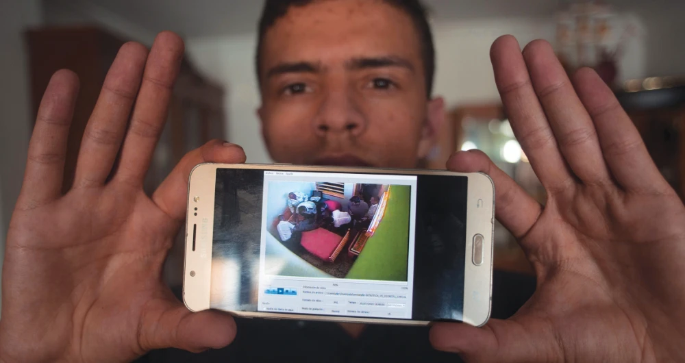 Anass Tahiri, 22, shows a video on his mobile phone capturing the death of his brother Iliass, at his home in San Roque, near Algeciras, on June 19. (AFP)