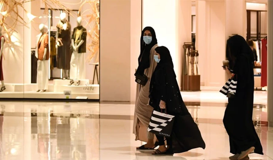 Women wearing masks for protection against the coronavirus, walk in the Mall of Dubai, UAE on April 28, 2020. (AFP)