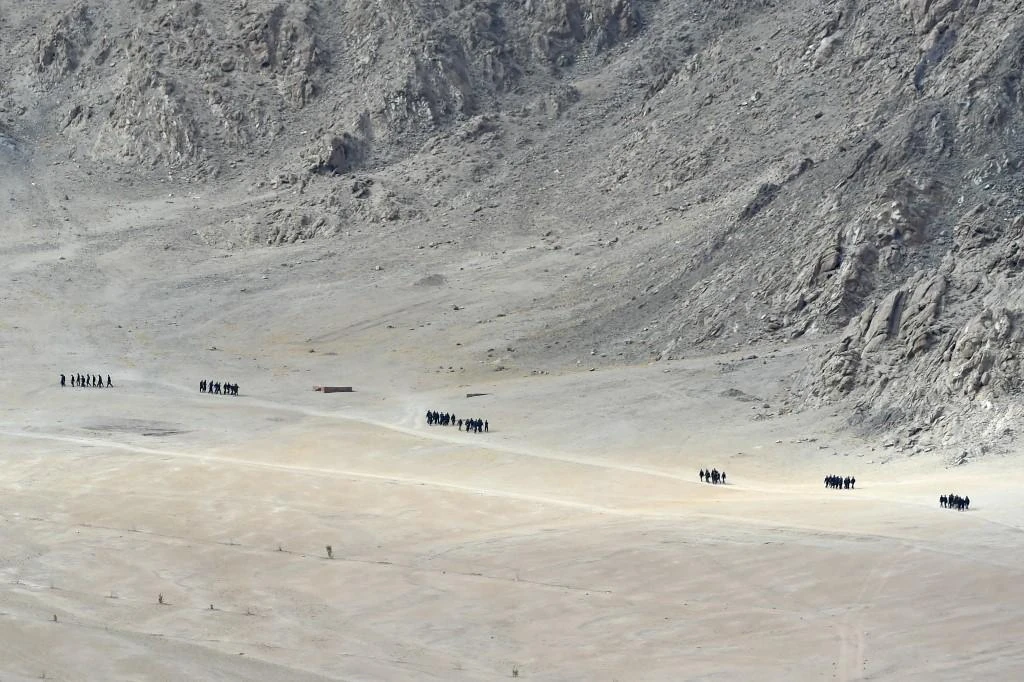 Indian soldiers walk at the foothills of a mountain range near Leh, the joint capital of the union territory of Ladakh. (AFP)